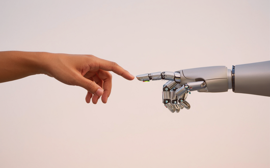 Human hand reaching out to touch a robot hand