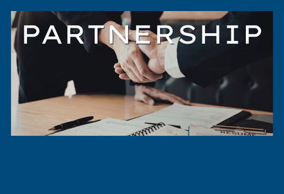 Two people shaking hands with the word Partnership overlayed
