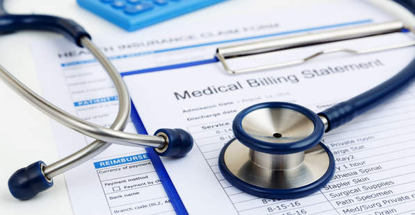 Medicare billing statement sample laying on a table with a stethoscope placed on top