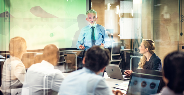 Stock image of a man leading a meeting in a conference room