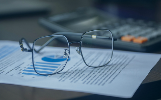 A pair of glasses on a sheet of paper to represent strategic pricing