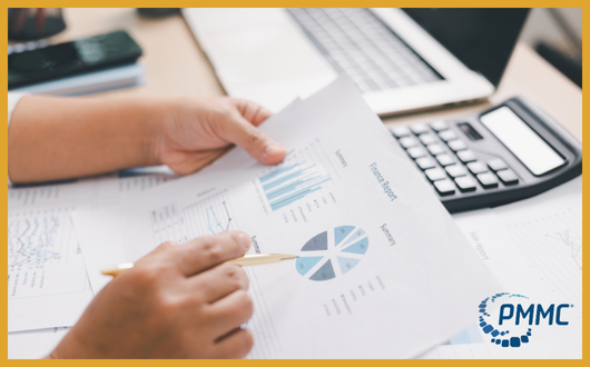 person working with a sheet of data and a calculator