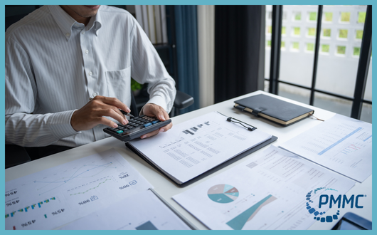 person working carefully with a calculator and paper with data