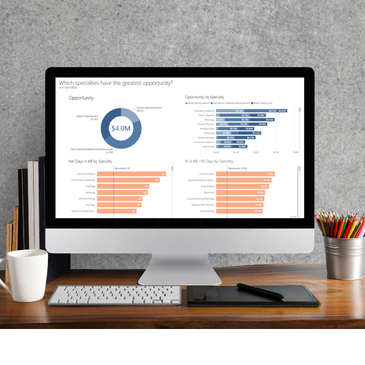 computer screen on a desk showing a PMMC dashboard report