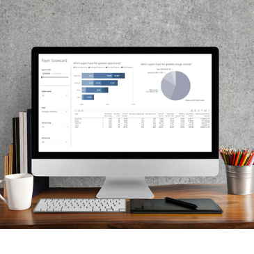computer screen on a desk showing a PMMC dashboard report