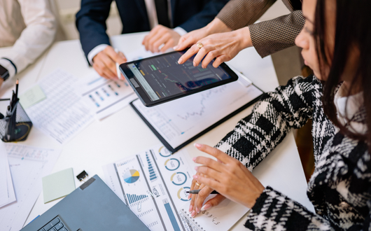 Photo of people collaborating around a set of data