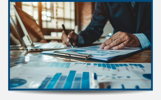 Image of a person managing a variety of sheets with charts and graphs